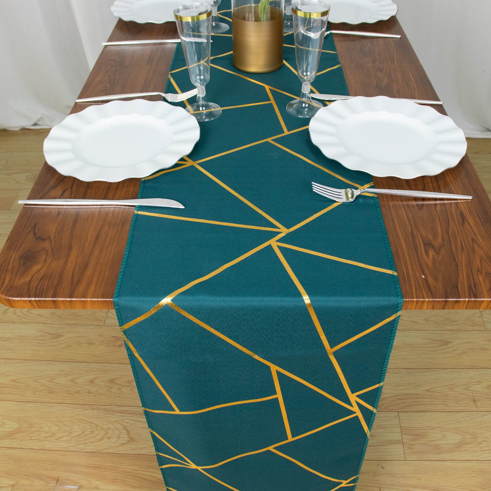 Peacock teal table runner with gold foil geometric pattern on a wooden table.