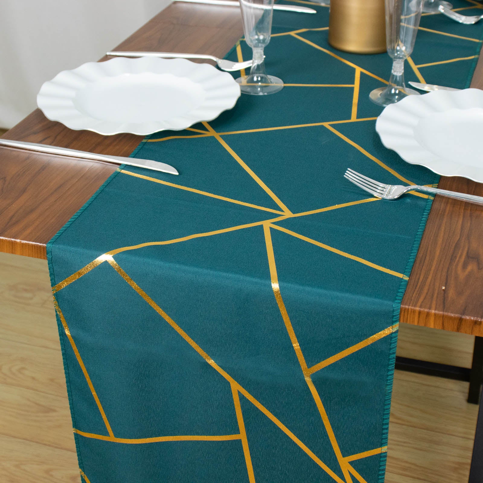 Peacock teal geometric pattern table runner with gold foil accents.