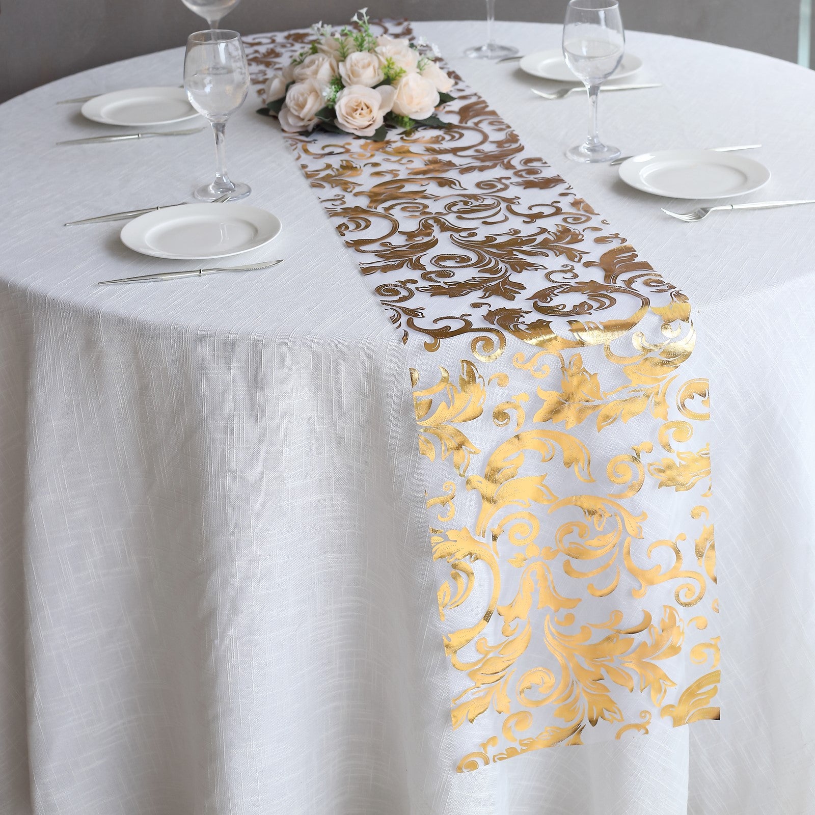 Metallic gold sheer organza table runner with swirl foil flower design.