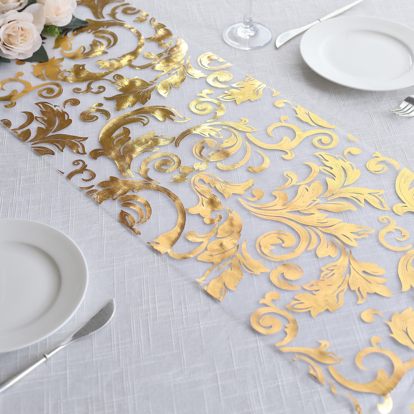 Metallic gold sheer organza table runner with swirl foil flower design.