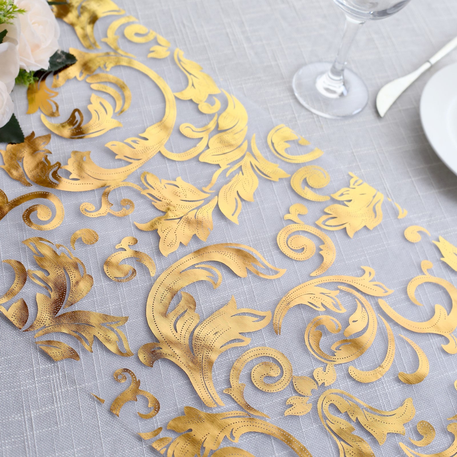 Metallic gold sheer organza table runner with swirl foil flower design.