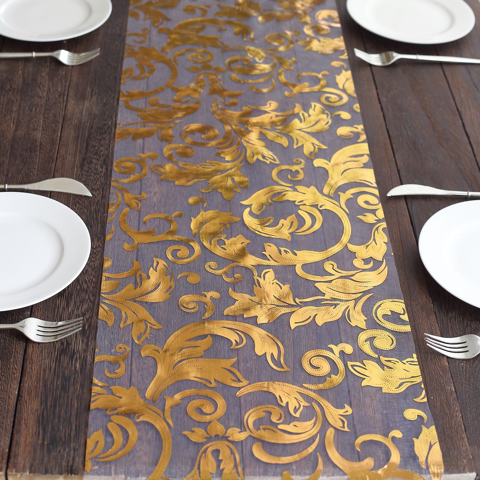Metallic gold sheer organza table runner with swirl foil flower design.