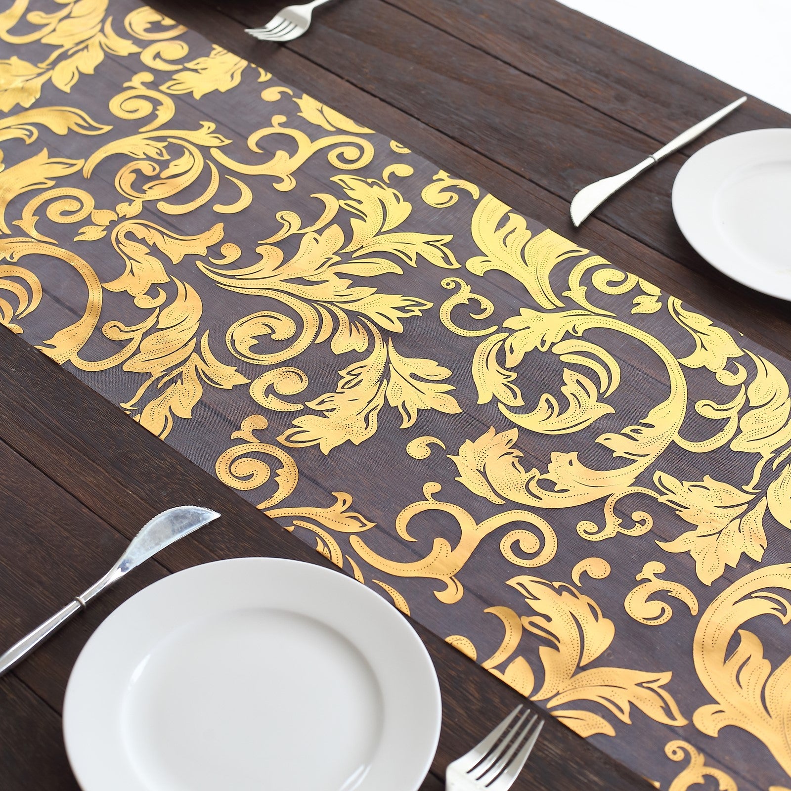 Metallic gold sheer organza table runner with swirl foil flower design.