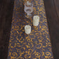 12"x108" Metallic Gold Mesh Table Runner with Embossed Foil Flower Design