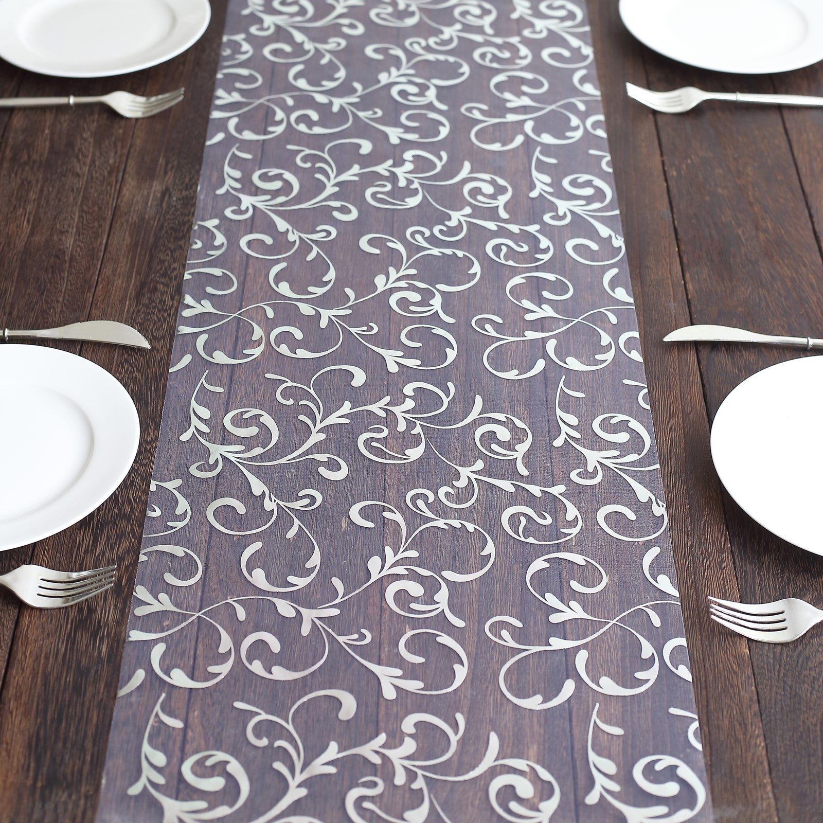 Metallic silver mesh table runner with embossed foil flower design.