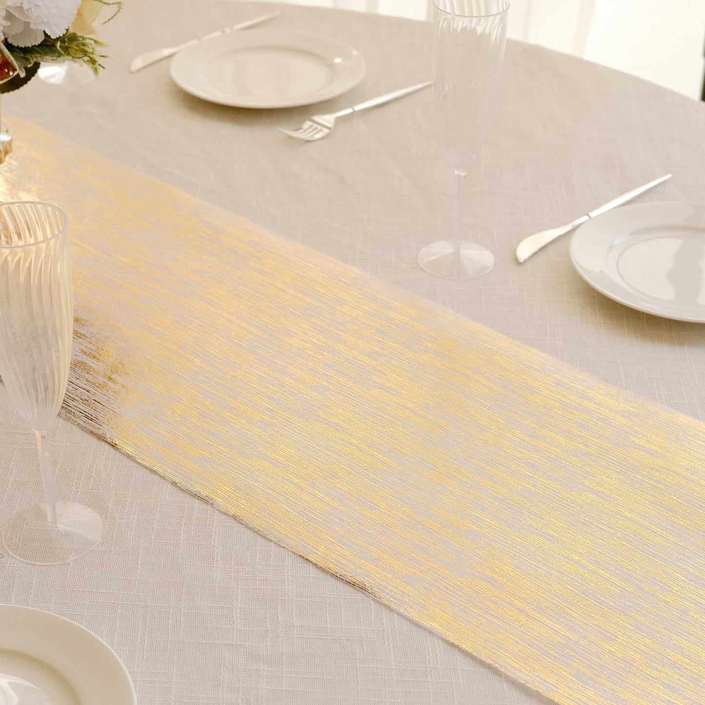 Metallic gold faux suede table runner on a dining table setting.
