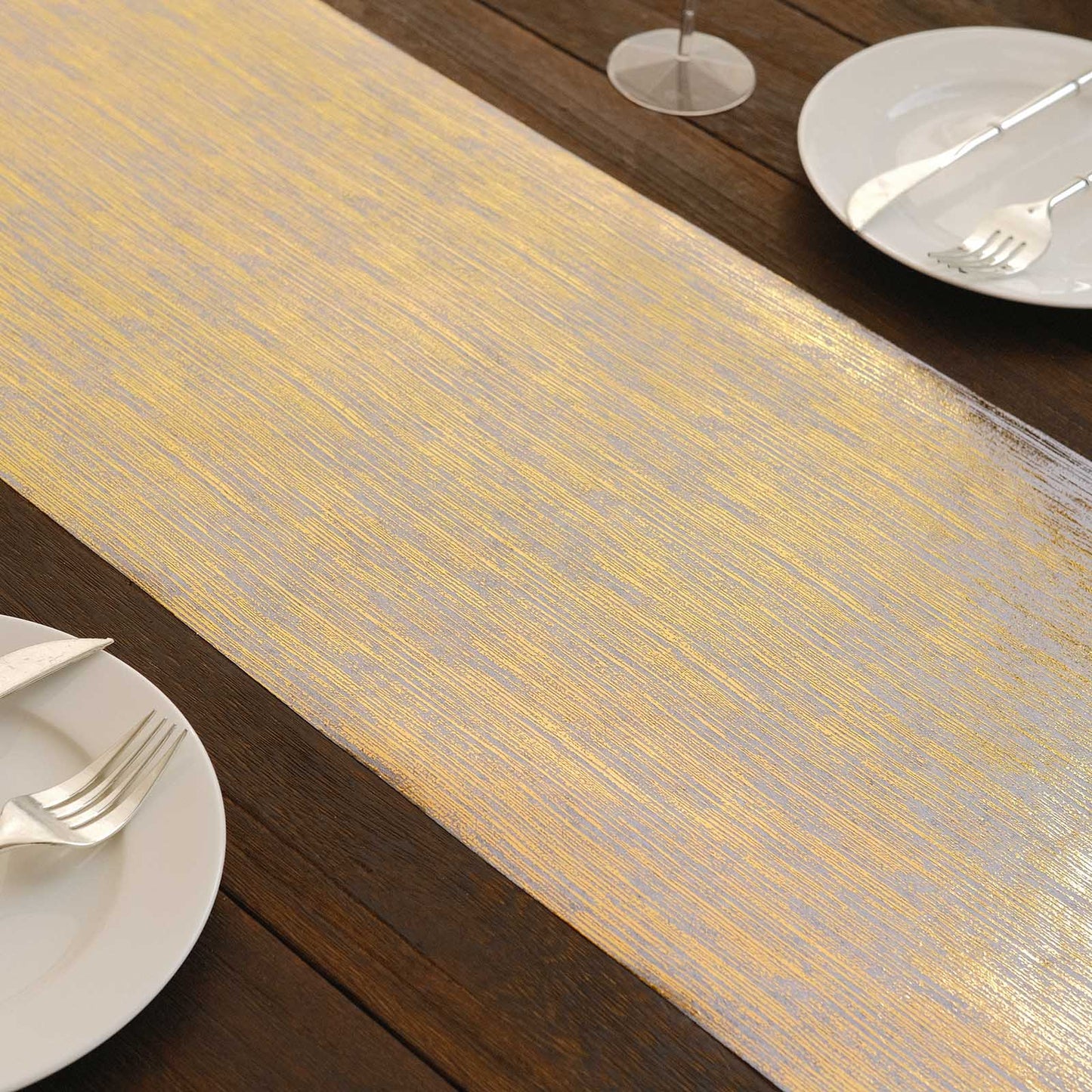 Metallic gold faux suede table runner on a wooden table setting.