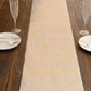 Metallic gold faux suede table runner on a wooden table setting.