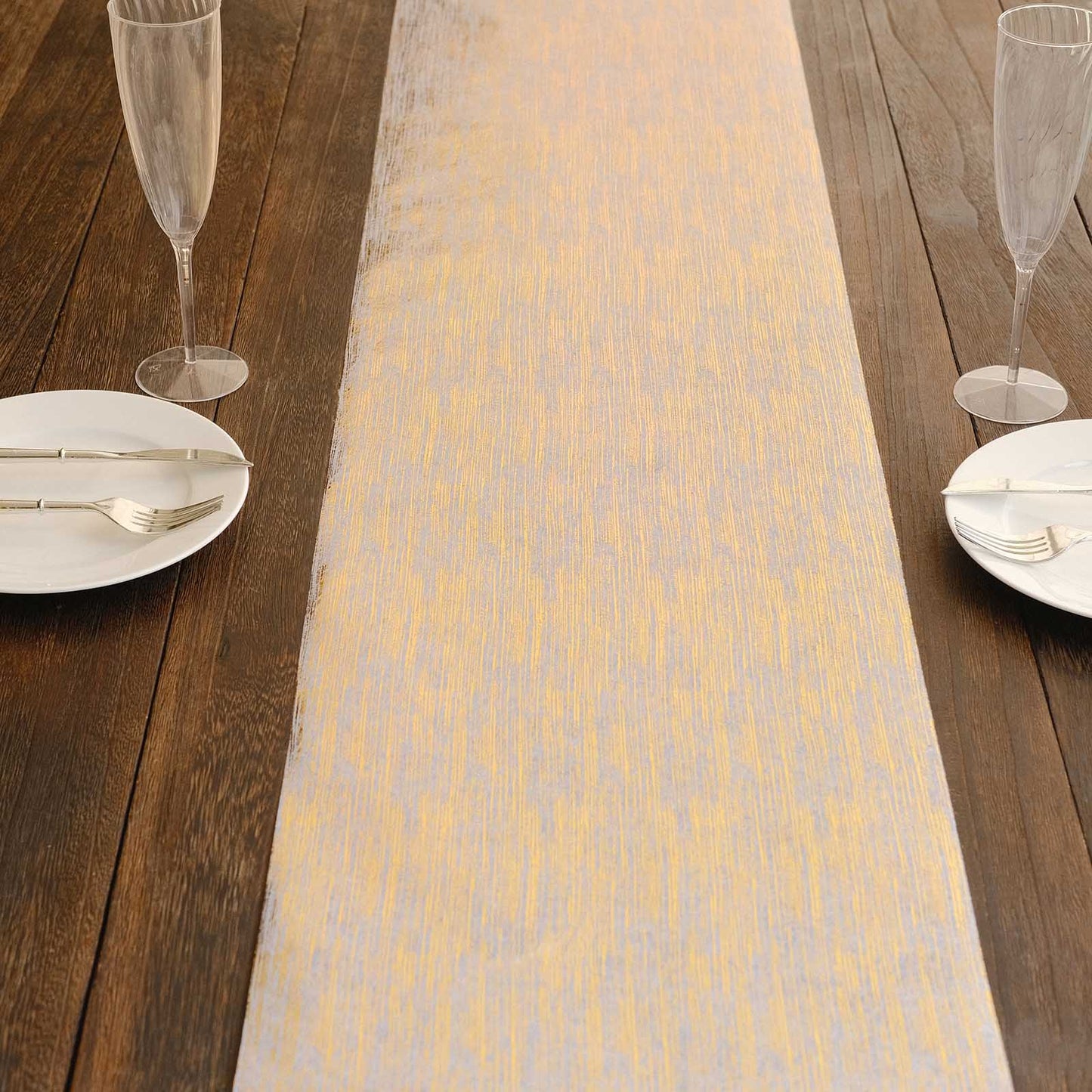 Metallic gold faux suede table runner on a wooden table setting.