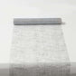 Metallic silver glitter mesh polyester disposable table runner on a white surface.