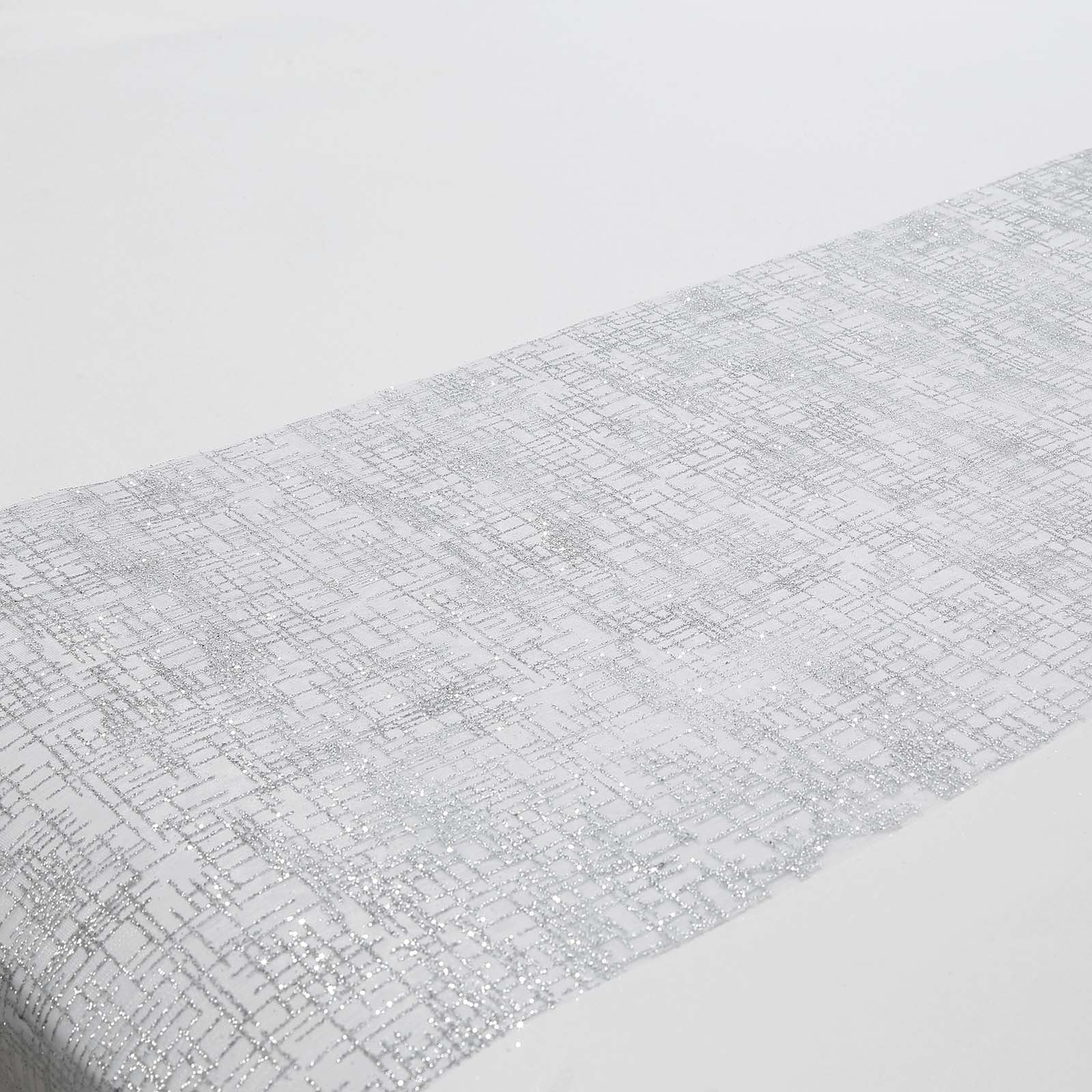 Metallic silver glitter mesh table runner on a white table.