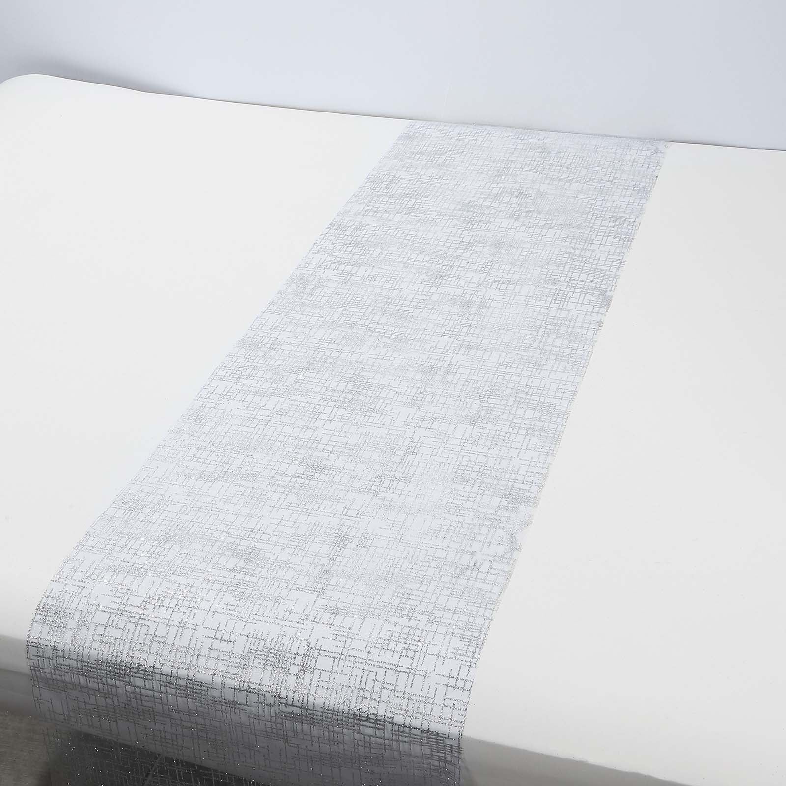 Metallic silver glitter mesh table runner on a white table.