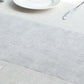 Metallic silver glitter mesh disposable table runner on a neutral table setting.