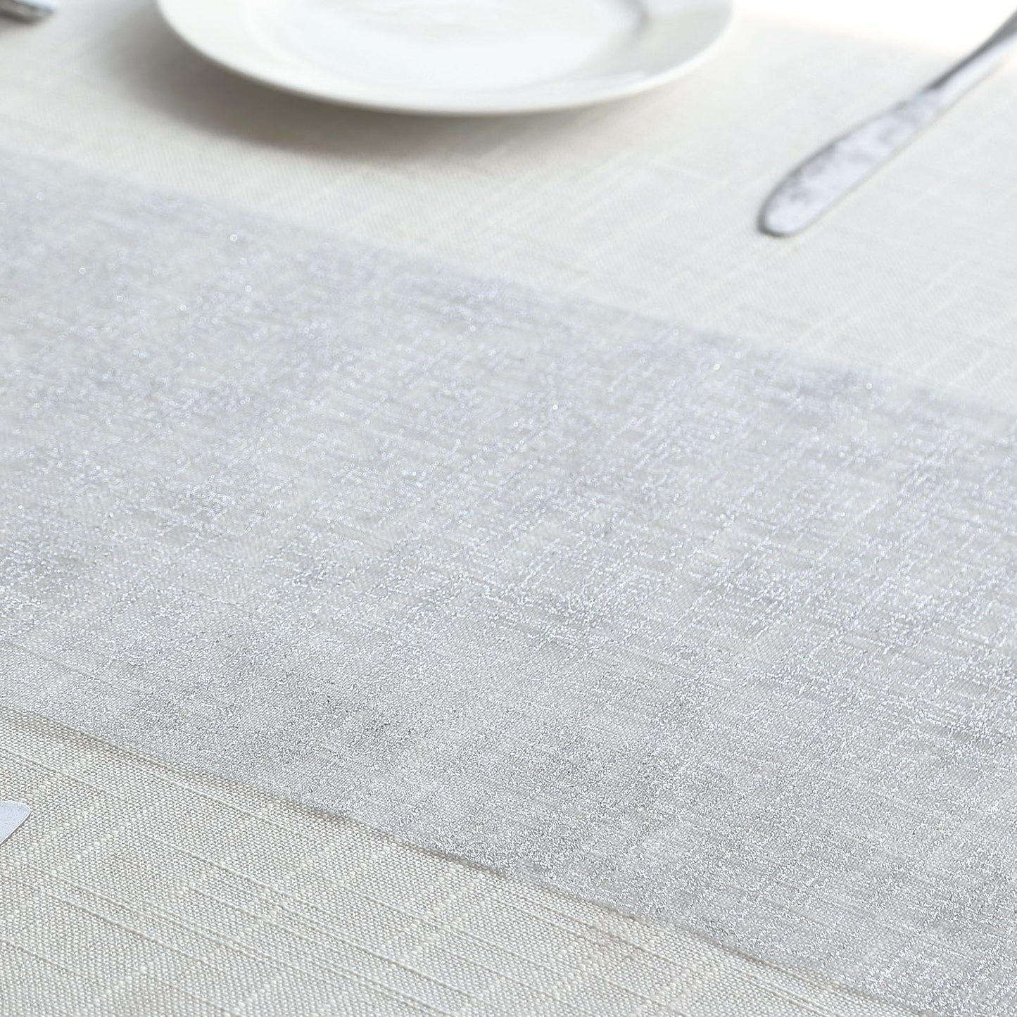 Metallic silver glitter mesh disposable table runner on a neutral table setting.