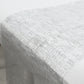 Metallic silver glitter mesh polyester disposable table runner on a white table.