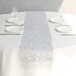 Metallic silver glitter table runner on a white table setting.