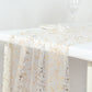 Metallic gold glitter sheer chiffon table runner on a white table.