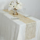 Gold mesh organza table runner with water wave pattern on a white table setting.
