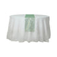 Emerald green mesh organza table runner with gold foil pattern on a white table.