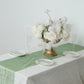 Emerald green mesh organza table runner with gold foil pattern on a dining table.