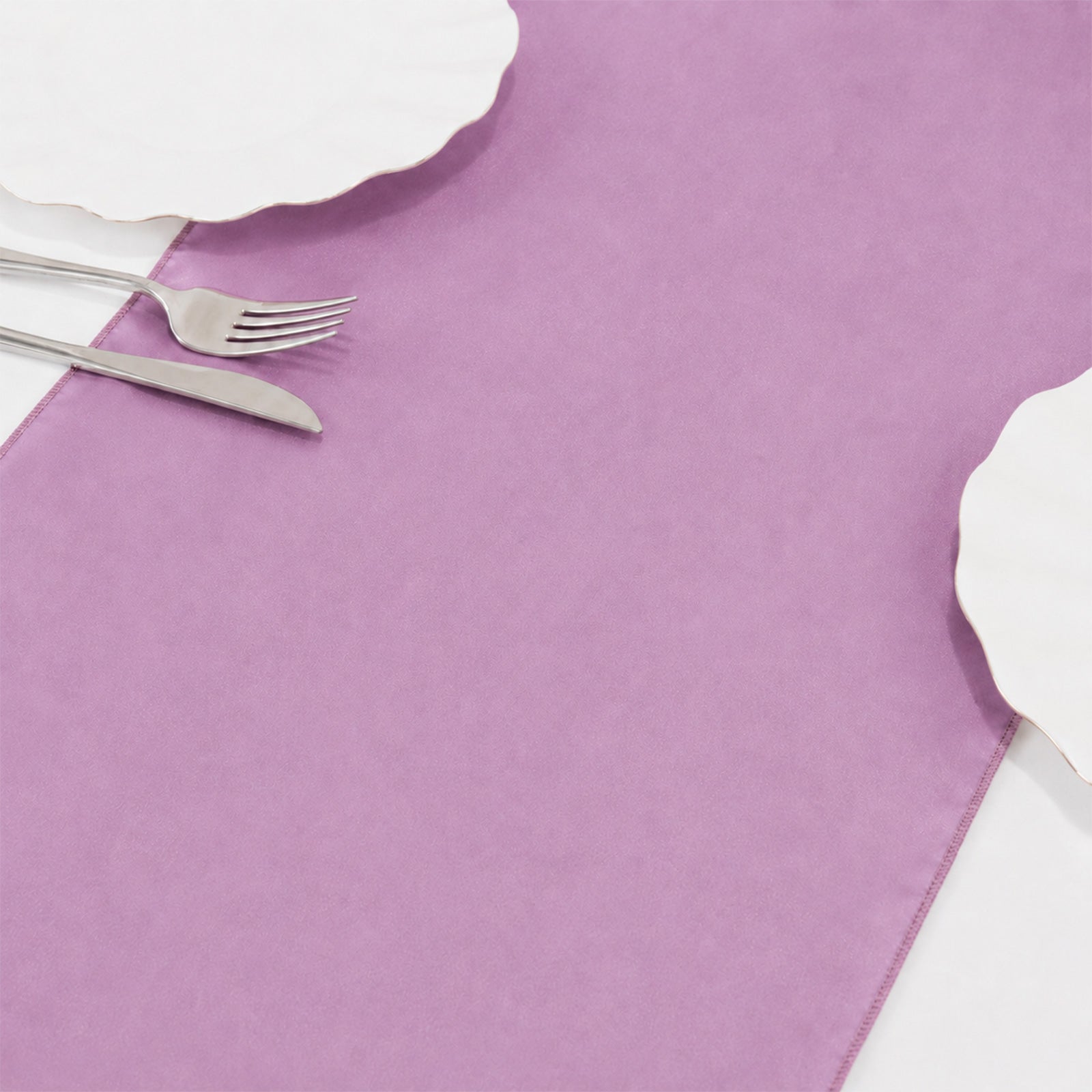 Fuchsia sheer organza table runner on a white table.
