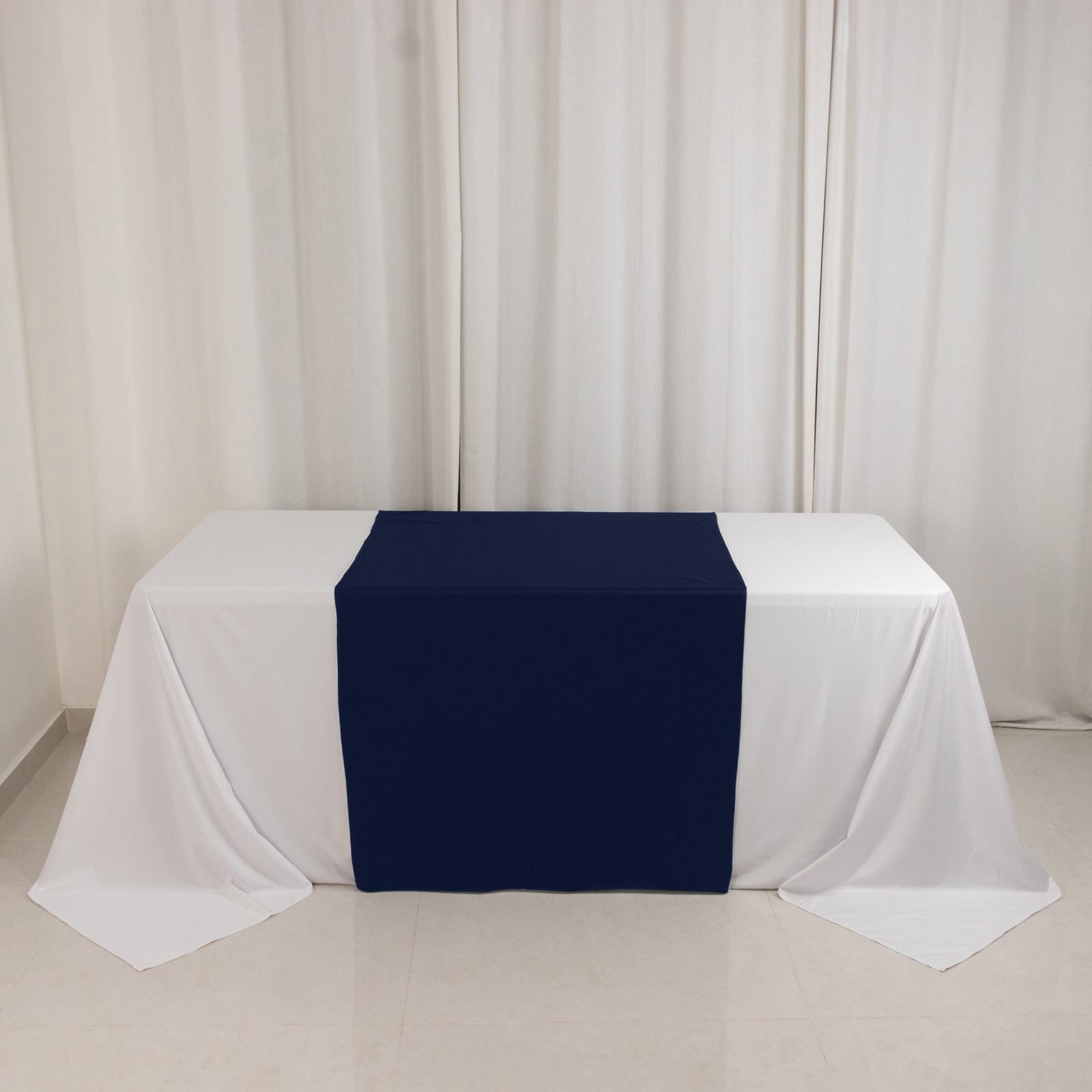 Navy blue table runner on a white table for trade shows.