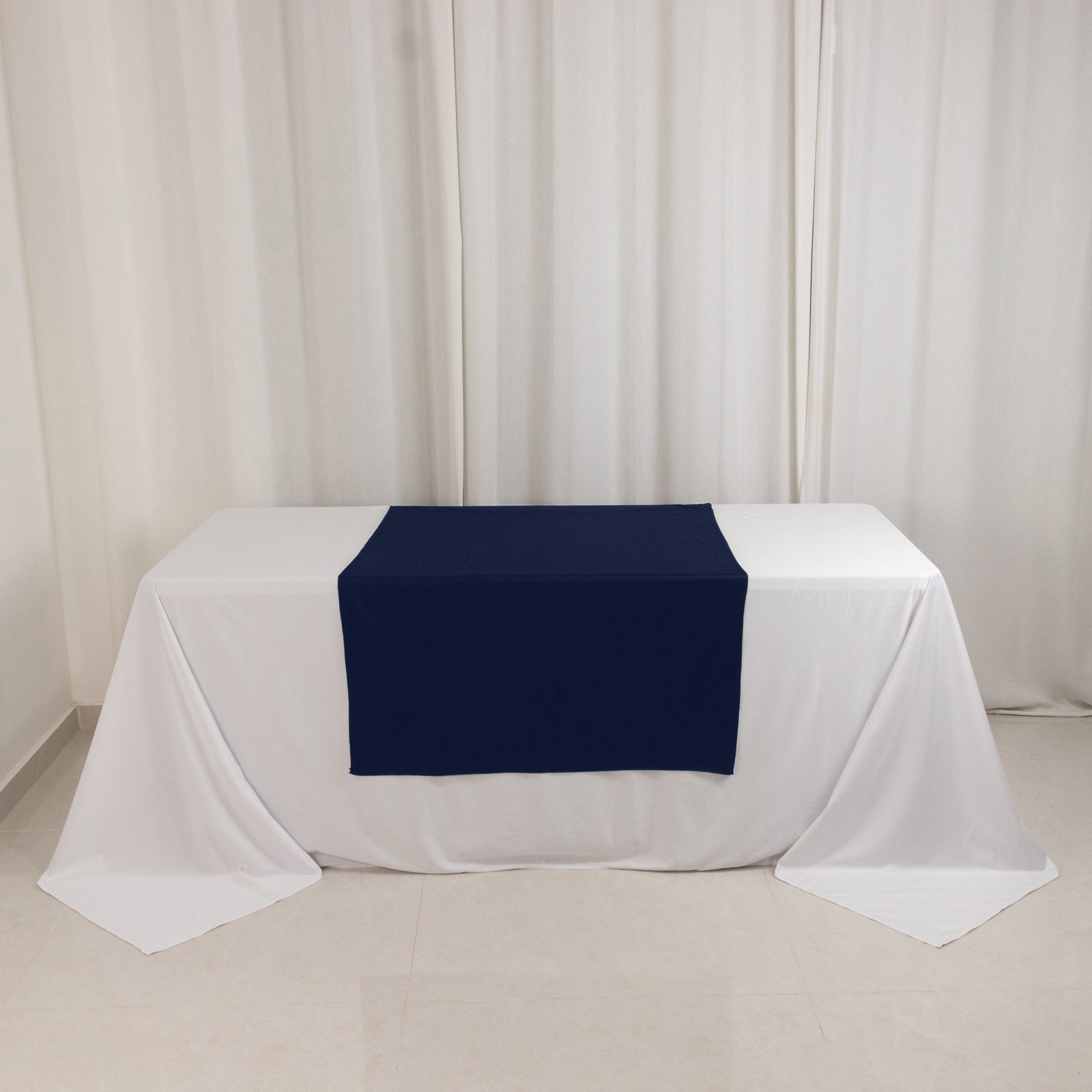 Navy blue table runner on a white tablecloth for trade shows.