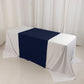 Navy blue table runner on a white table in a trade show setting.