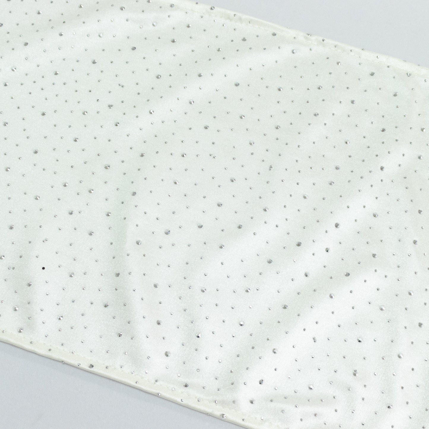Pearl white scuba table runner with rhinestone accents.