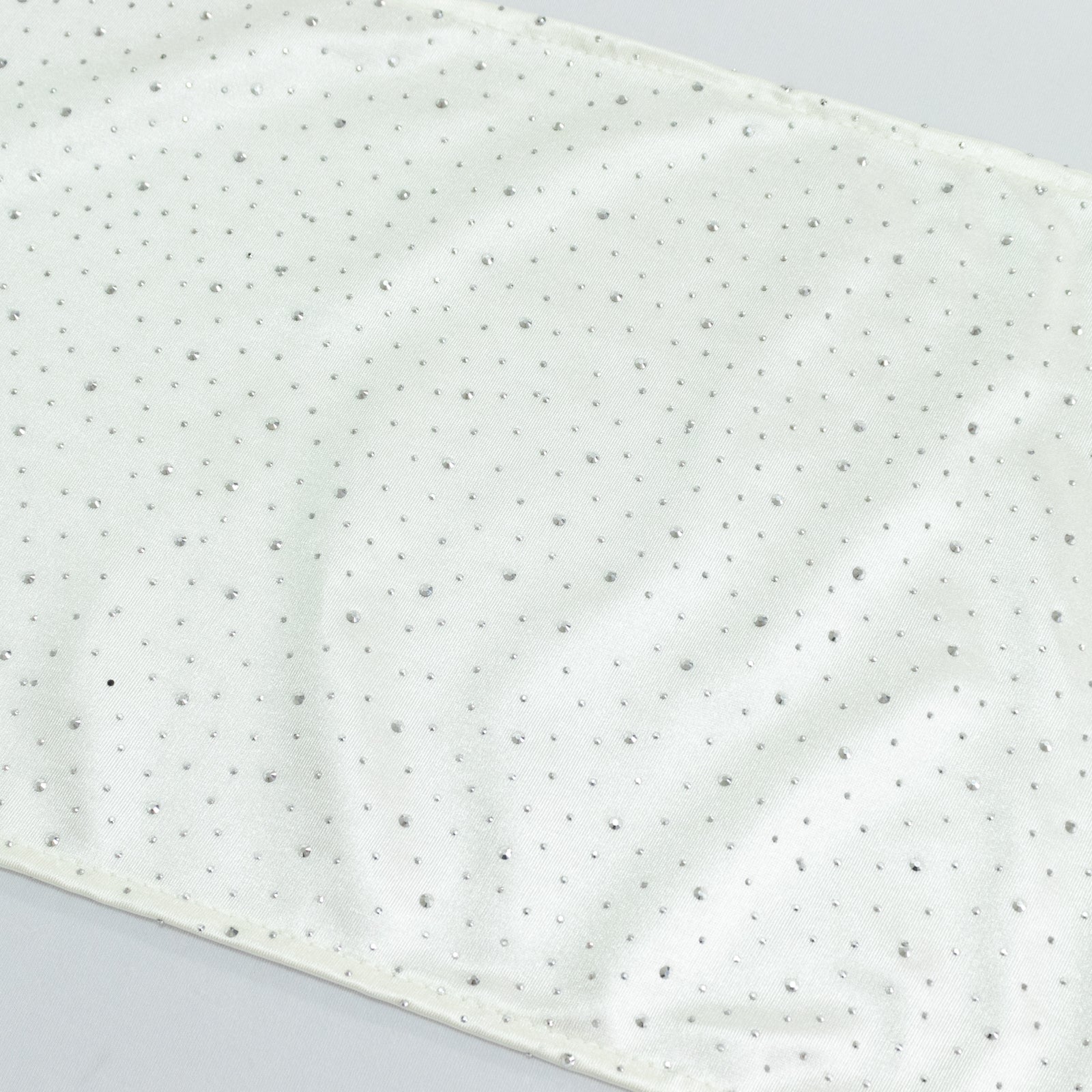 Pearl white scuba table runner with rhinestone accents.
