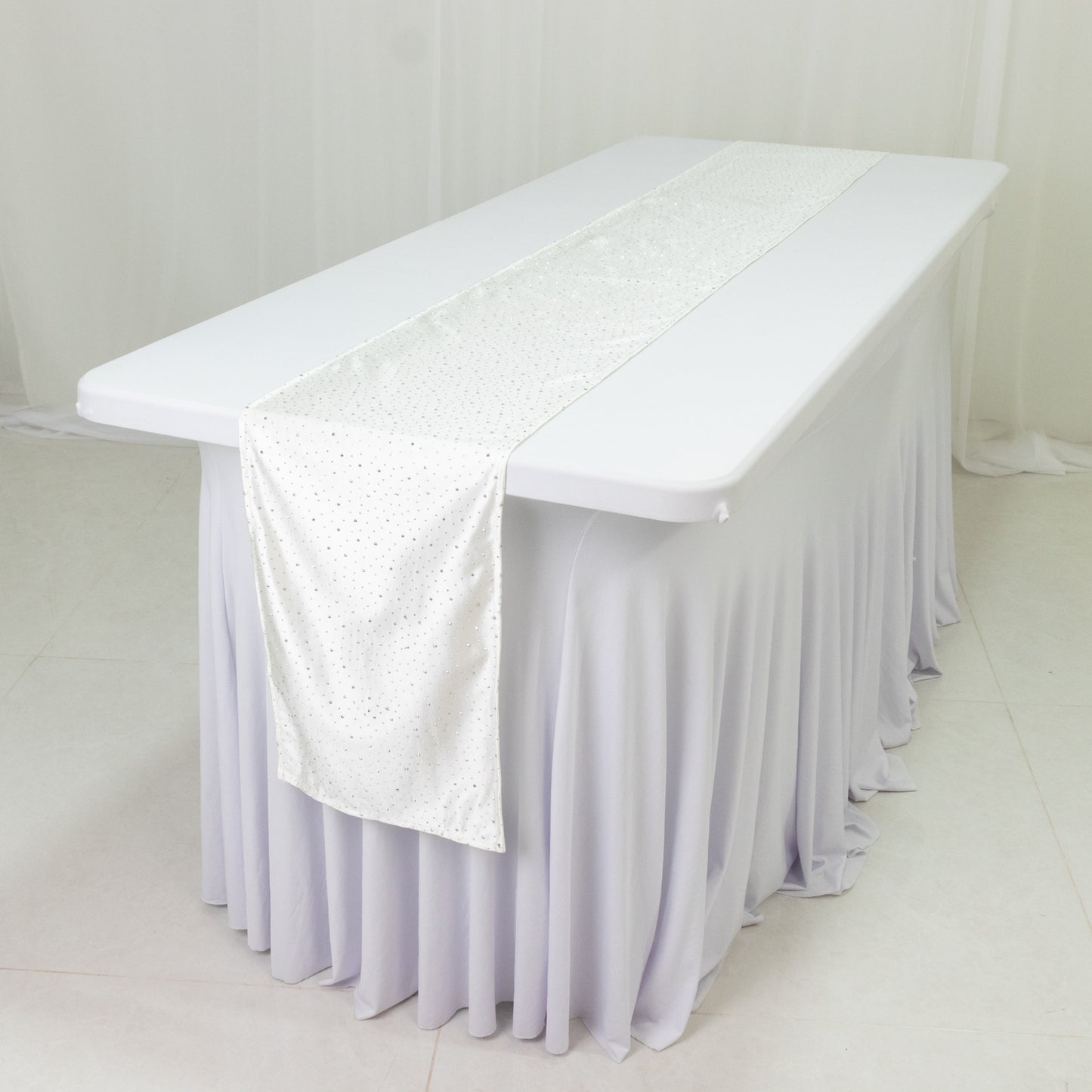 Pearl white scuba table runner with rhinestone accents on a white table.