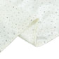 Pearl white scuba table runner with rhinestone accents and a wrinkle-free finish.