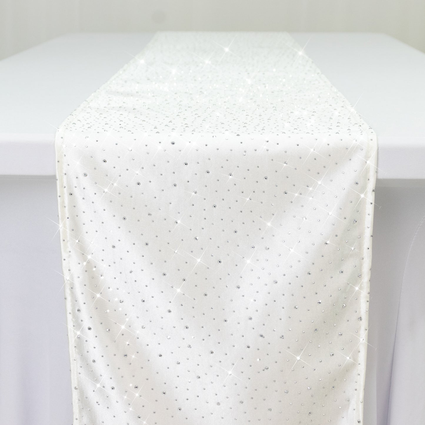 Pearl white scuba table runner with rhinestone accents on a table.