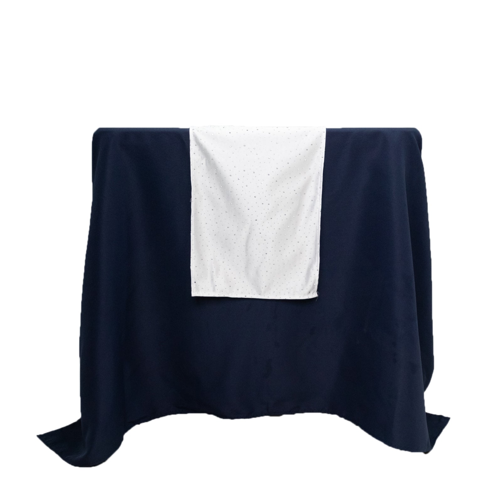 White scuba table runner with rhinestone accents on a dark blue table.