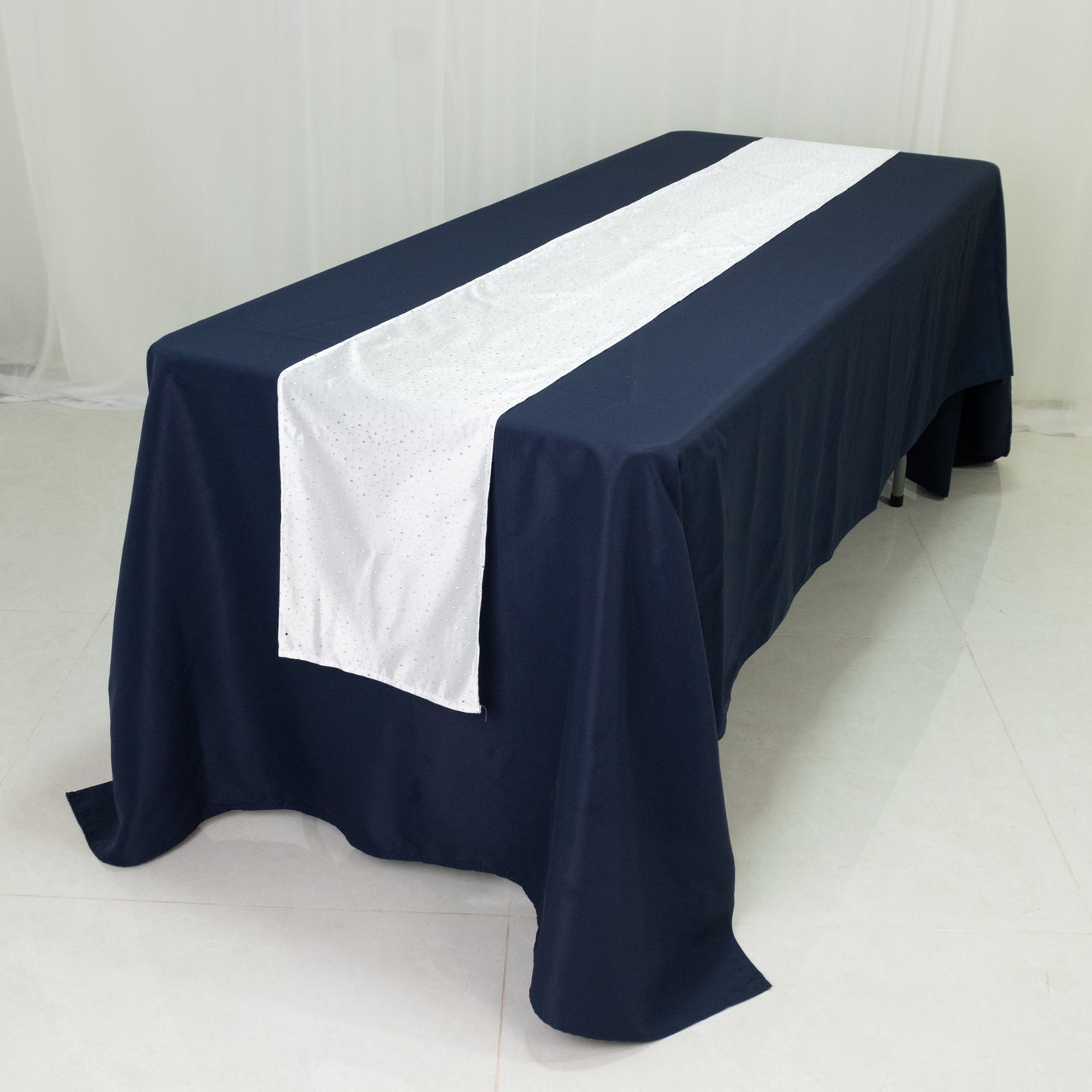 Navy table with a white rhinestone-accented scuba runner.