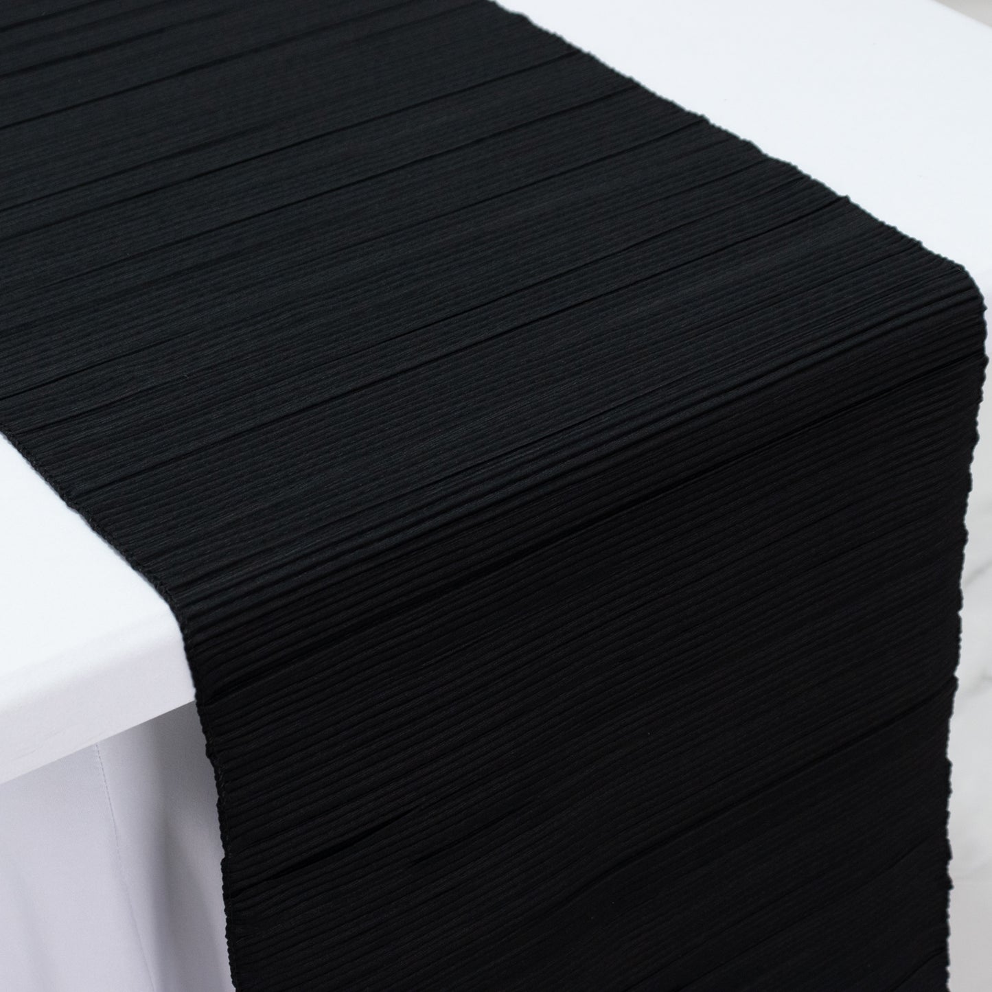 Black accordion pleated table runner, 12" x 108", wrinkle free and stain resistant.