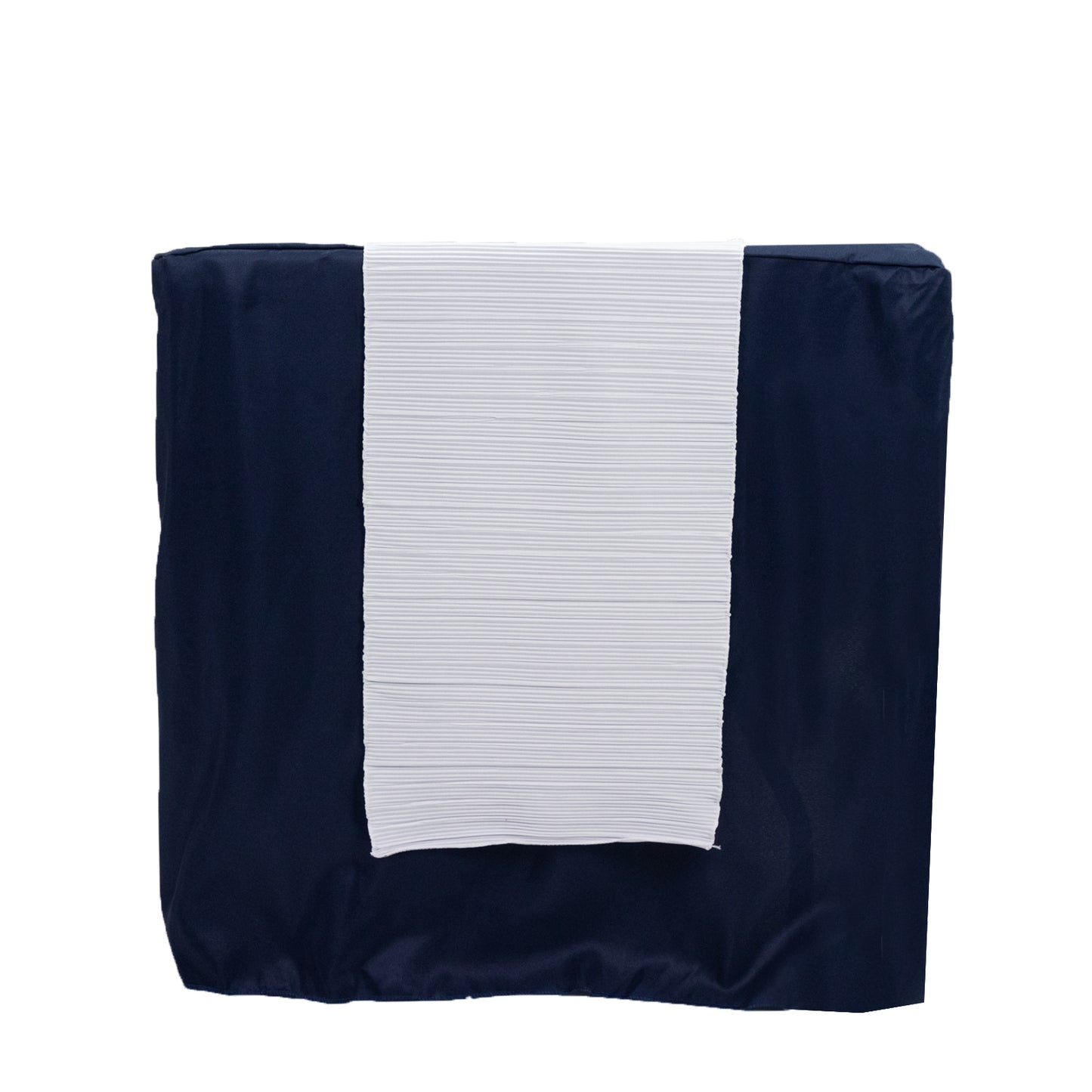 White accordion pleated table runner on a navy blue table.