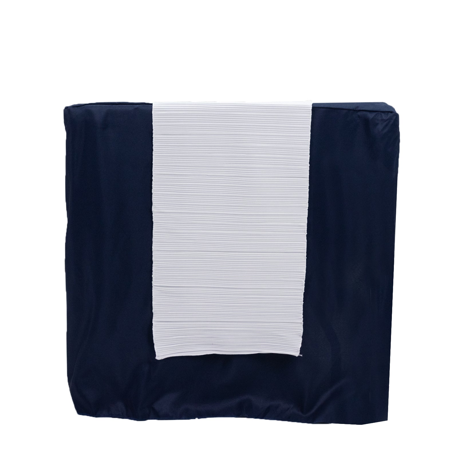 White accordion pleated table runner on a navy blue table.