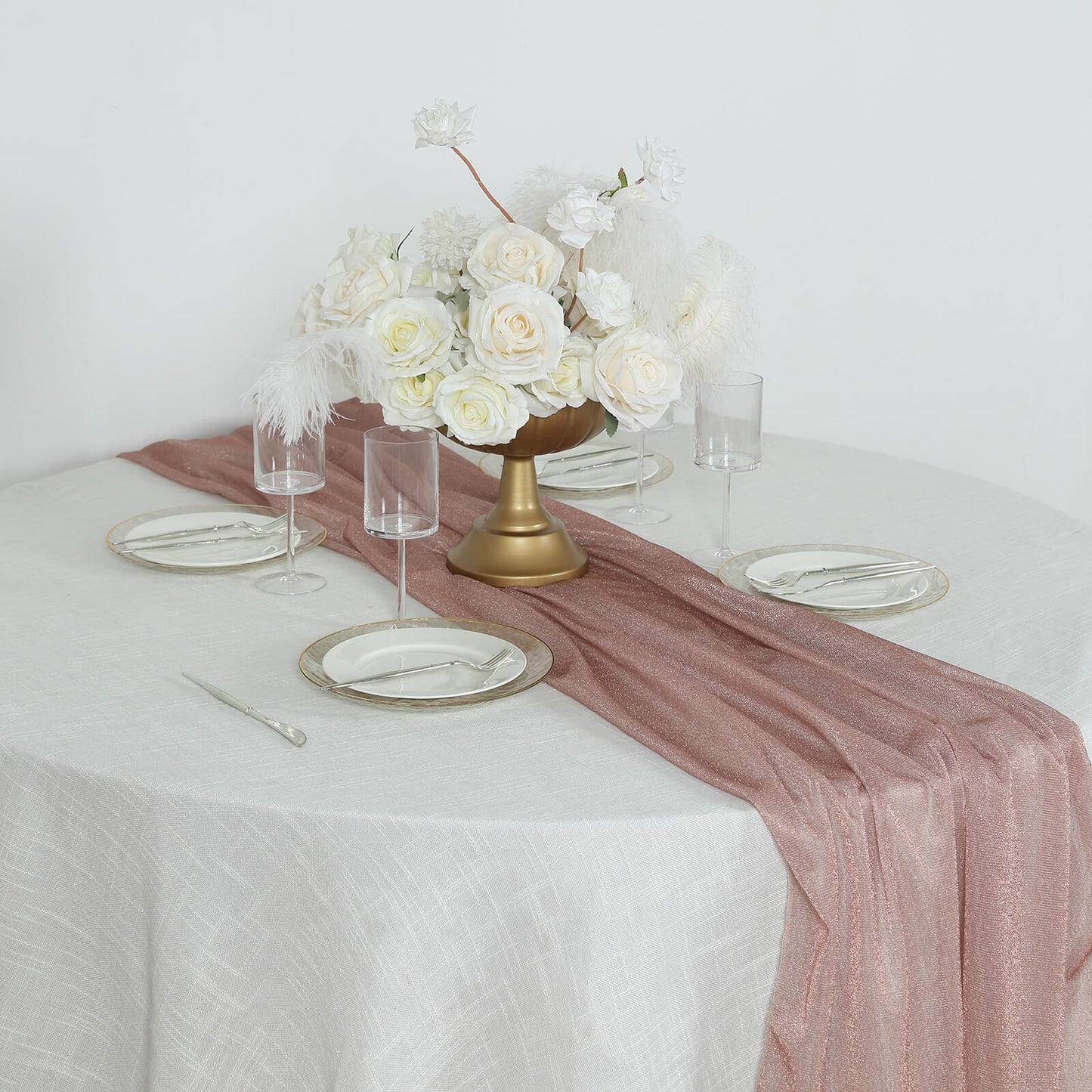 Rose gold sparkling glitter gauze table runner on a dining table.