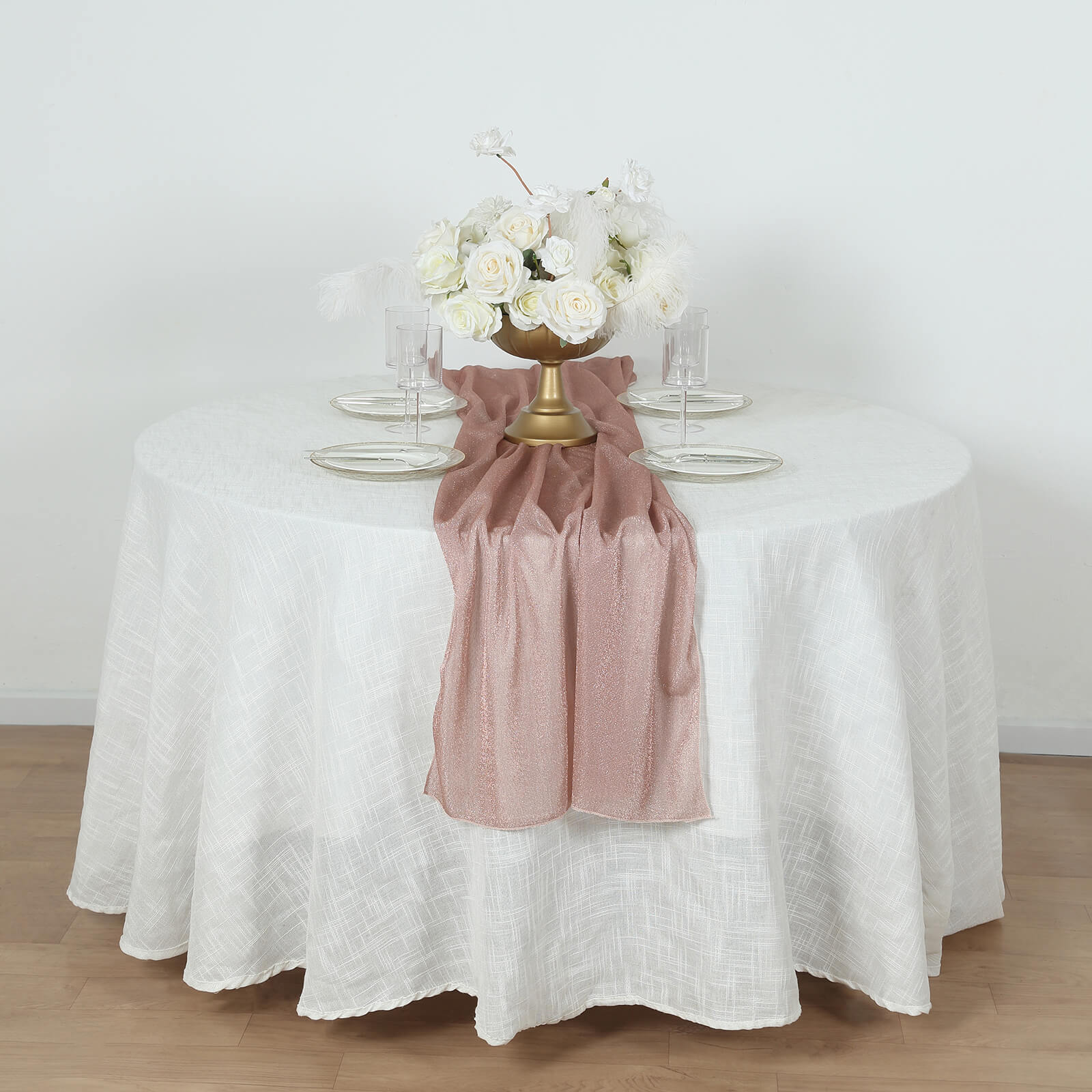 Rose gold sparkling glitter sheer table runner on a white table.