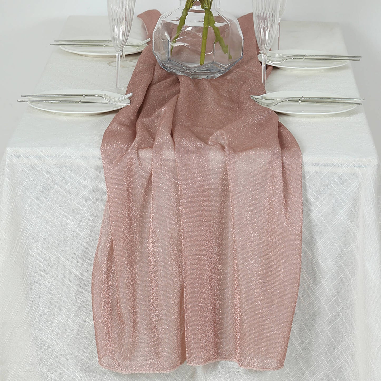 Rose gold sparkling glitter table runner on a white table setting.