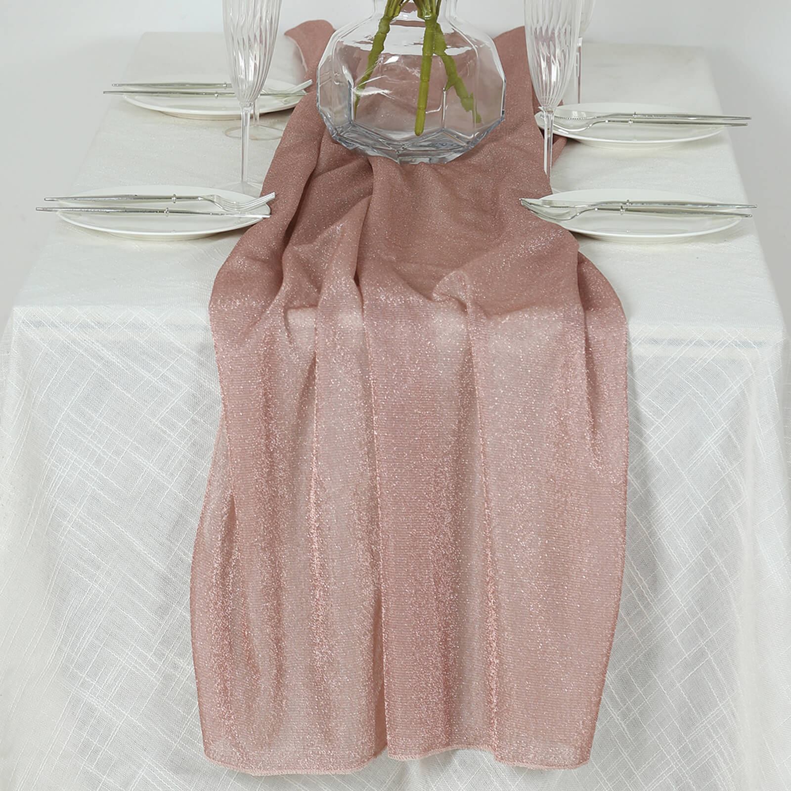 Rose gold sparkling glitter table runner on a white table setting.