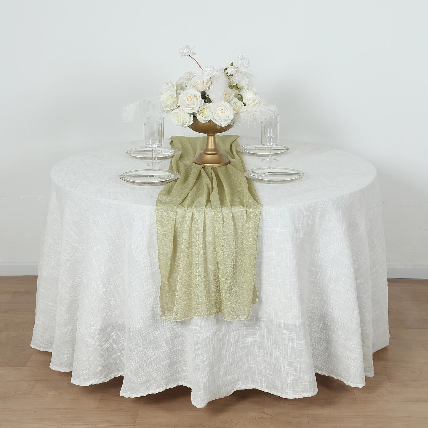 Champagne glitter gauze table runner on a round white table.