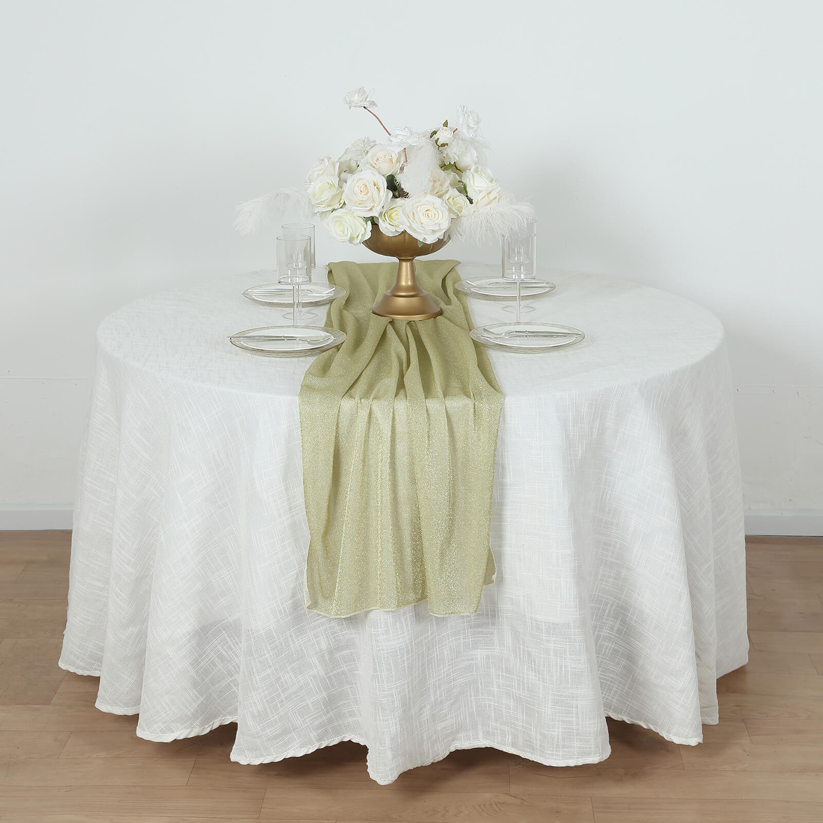 Champagne glitter gauze table runner on a round white table.