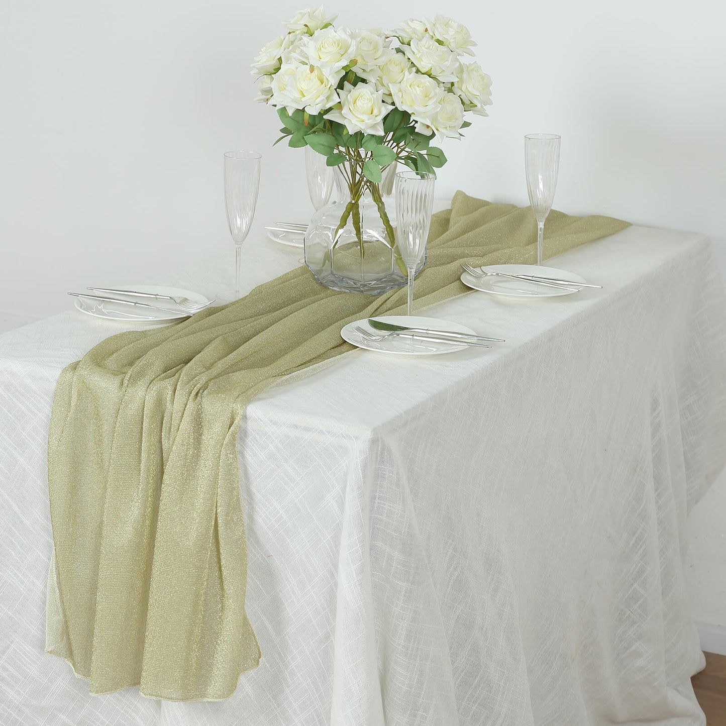 Champagne sparkling glitter gauze table runner on a white table.