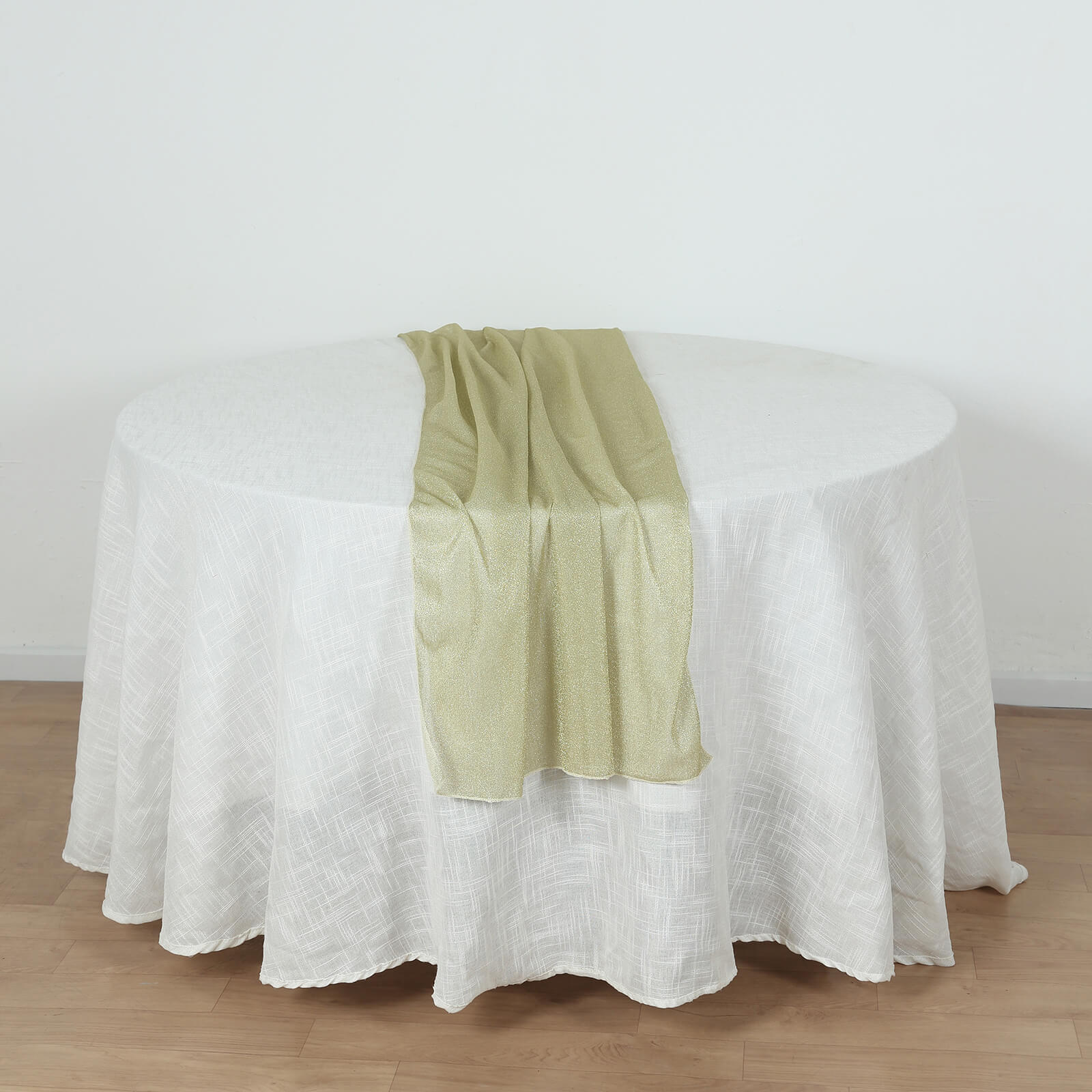 Champagne sparkling glitter gauze table runner on a white table.