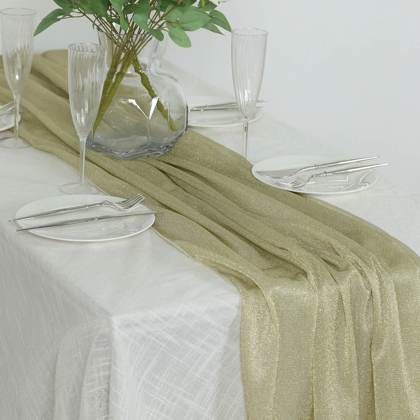Champagne sparkling glitter gauze table runner on a white table.
