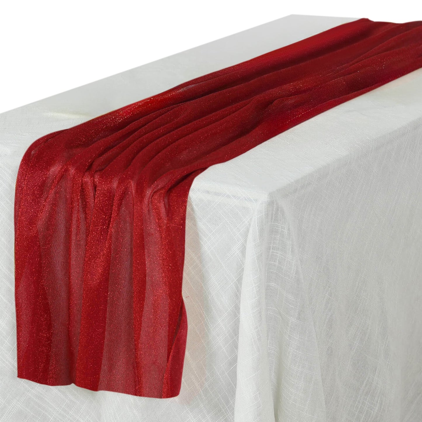 Red glitter gauze table runner on a white table.