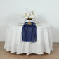 Royal blue glitter gauze table runner on a round white table with floral arrangement.