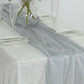 Silver sparkling glitter table runner on a white table setting.